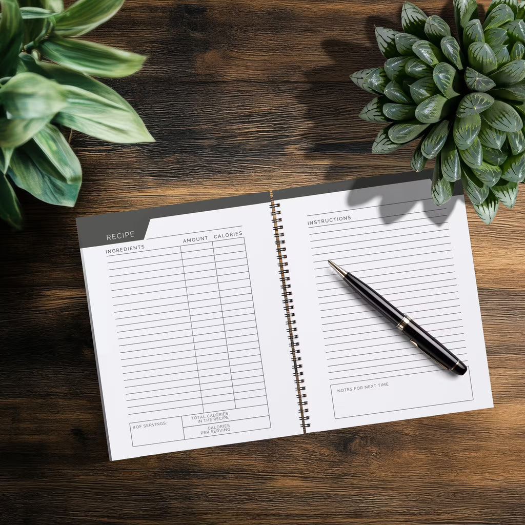 Open notebook showing blank recipe pages in the TRACK Journals 90 Day Calories Tracker.