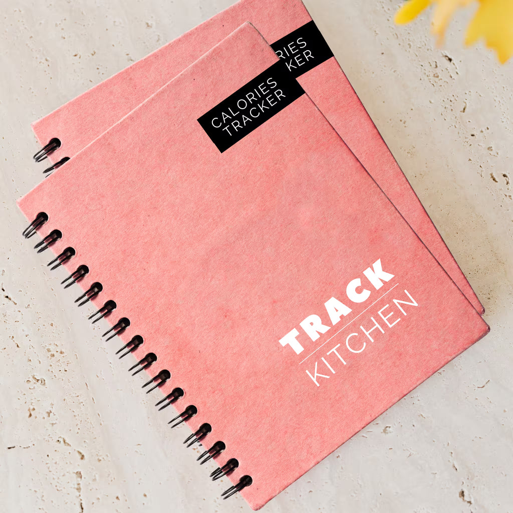 Salmon pink spiral-bound notebook 90 Day Calories Tracker diet journal