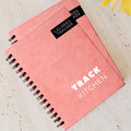 Salmon pink spiral-bound notebook 90 Day Calories Tracker diet journal